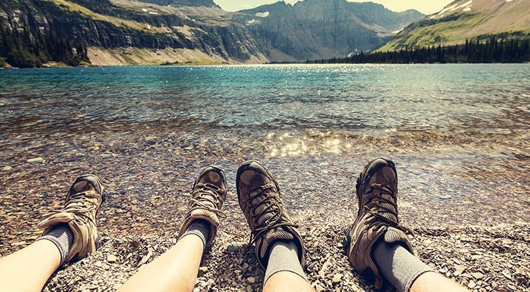 Travellers sitting next to lake