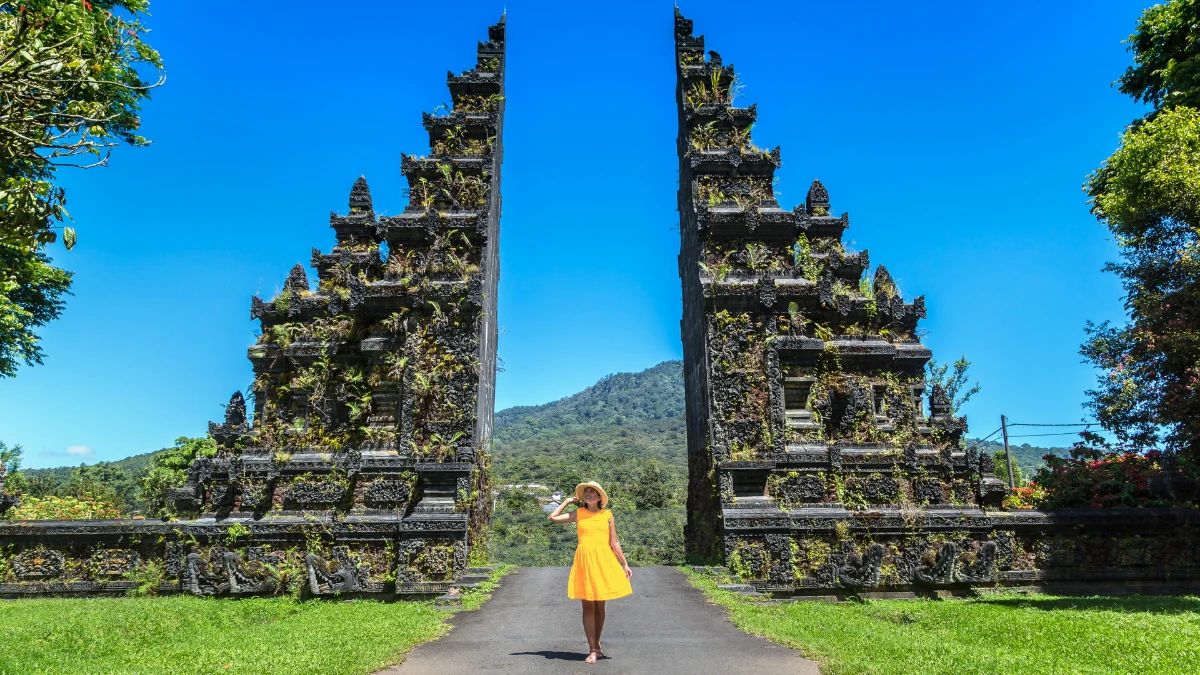 do you need a visa for bali? woman in yellow dress visiting bali temple