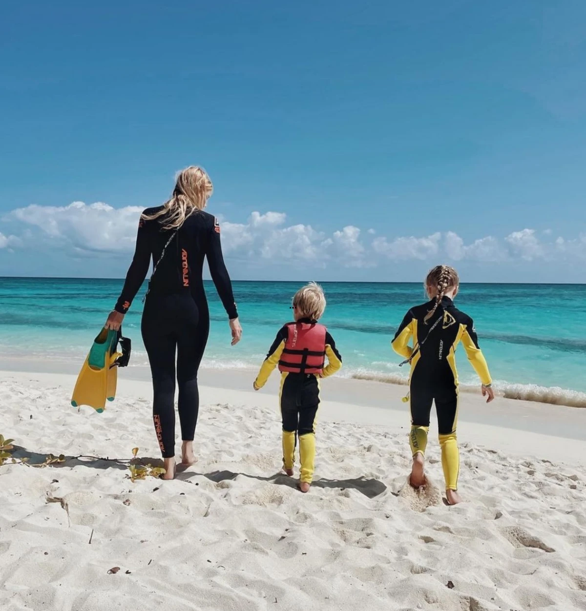 woman and two kids on beach