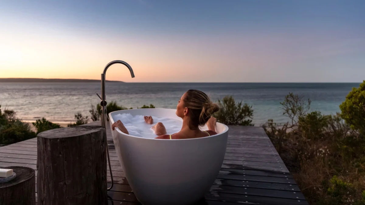 woman in bathtub overlooking beach on kangaroo island
