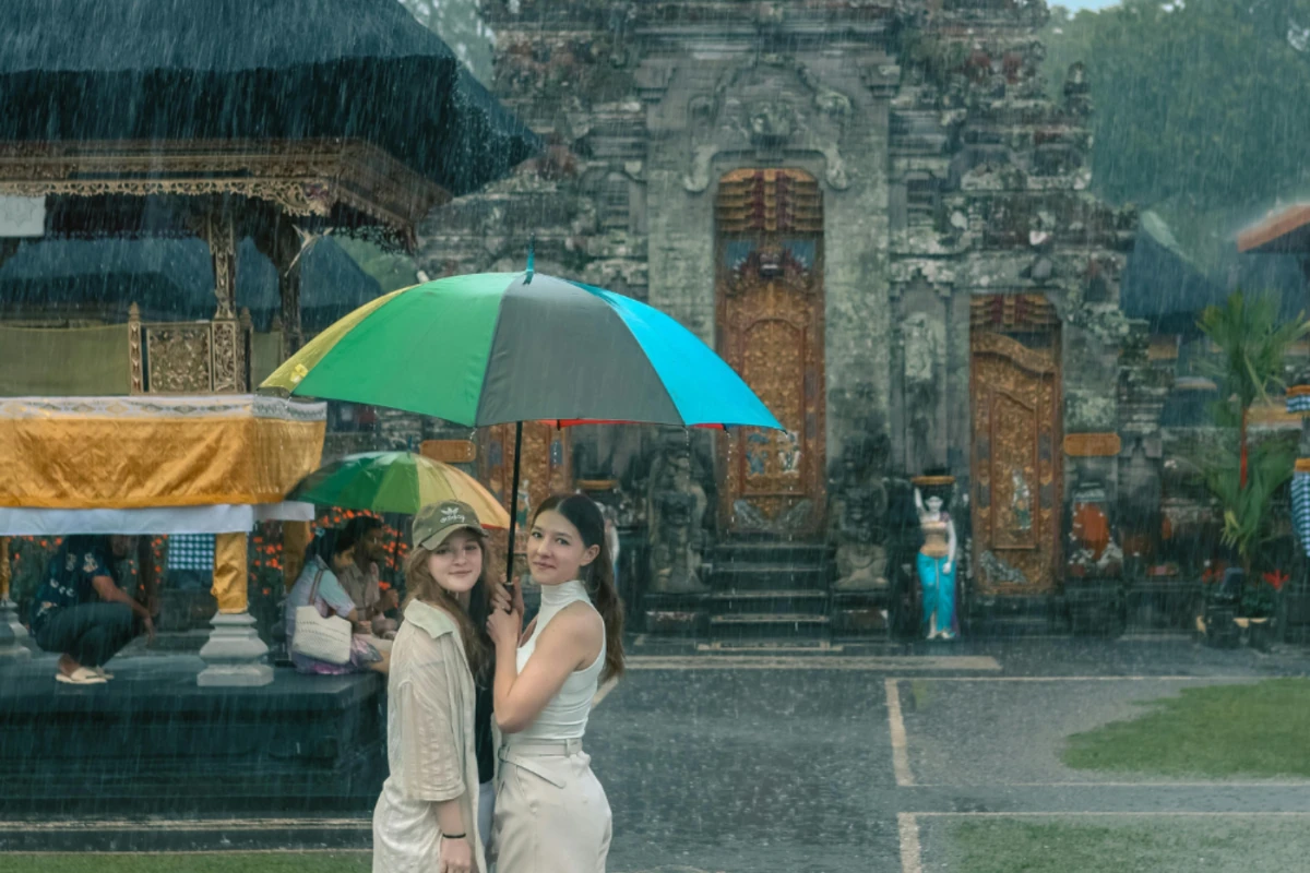 two girls standing in the rain in bali