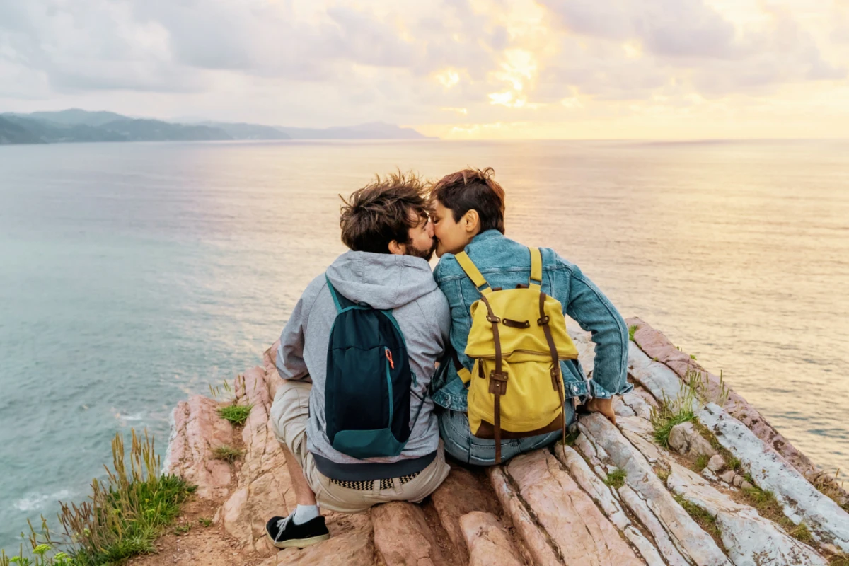couple kissing on cliffside
